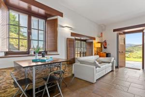 a living room with a table and a couch at L de Alborada del Eo in Villameitide