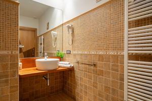 a bathroom with a sink and a mirror at L de Alborada del Eo in Villameitide +32 photos