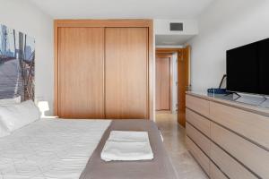 a bedroom with a bed and a flat screen tv at Hollywood A111 in Mijas Costa