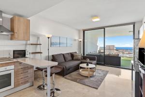 a kitchen and living room with a couch and a table at Hollywood A111 in Mijas Costa
