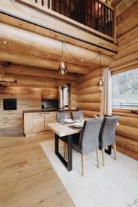 a dining room with wooden walls and a table and chairs at Chalet Zwoasom in Grossarl