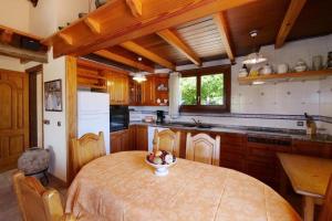 a kitchen with a table with a bowl of fruit on it at Sa Vinyeta de Son Jaumell in Capdepera