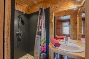 a bathroom with two sinks and a shower at Chalet du Pradel in Les Estables +22 photos