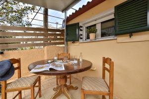 a wooden table and chairs on a patio at Erietas House in Ágios Matthaíos