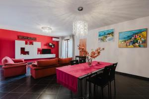 a red living room with a table and a couch at Casa Cuore in Marsala