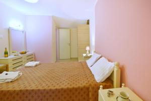 a small bedroom with a bed and a sink at Erietas House in Ágios Matthaíos