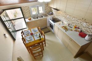 a small kitchen with a table and chairs in it at Erietas House in Ágios Matthaíos