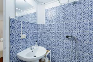 a blue tiled bathroom with a sink and a shower at Casa Mar Azul Arinaga in Arinaga +64 photos
