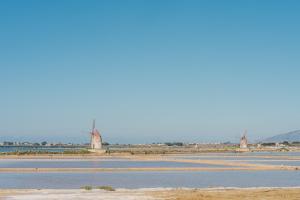 a group of windmills in the middle of a river at Casa Cuore in Marsala