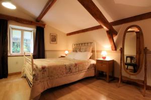 a bedroom with a bed and a large window at La Gourmantine in Polignac