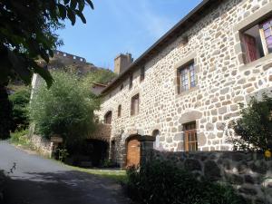 a large stone building with a road in front of it at La Gourmantine in Polignac +42 photos
