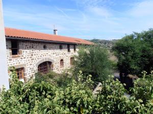 a brick building with a red roof at La Gourmantine in Polignac