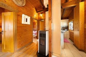 a kitchen with a stove in the middle of a room at Orserose Chalet 1 La Bilancia in Forno di Zoldo