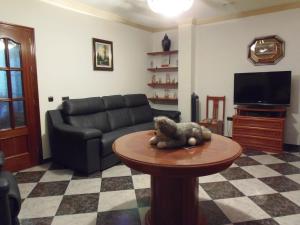 a living room with a couch and a stuffed animal on a table at Casa José Romero in Arriate