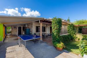 a house with a ping pong table in the yard at Casa Paqui Alcudia in Port d'Alcudia