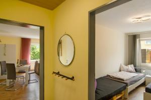 a bedroom with a yellow wall and a mirror at Harzblick am Waldesrand in Hahausen