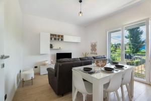 a living room with a white table and a couch at Villa Lilia in Arona