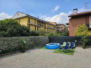 a backyard with two chairs and a swimming pool at Villa Lilia in Arona