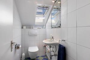 a bathroom with a sink and a toilet and a mirror at Casa Di Napolitano 4 in Radolfzell am Bodensee +23 photos