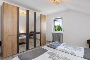 a bedroom with a bed and a large glass wall at Casa Di Napolitano 4 in Radolfzell am Bodensee