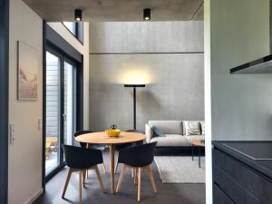 a dining room and living room with a table and chairs at Ferienhaus Schlossterrassen 8a in Pouch