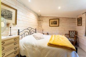 a bedroom with a bed and a dresser and a chair at Studio avec piscine à Avignon in Avignon