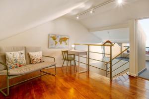 a living room with a couch and a table at Casa do Loureiro in Funchal