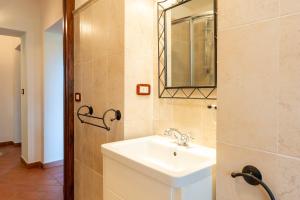 a bathroom with a sink and a mirror at Podere Villa Rosa Torrita di Siena in Torrita di Siena +23 photos