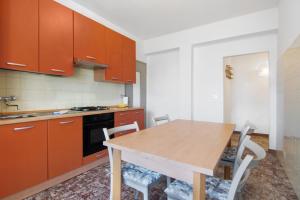 a kitchen with a wooden table and chairs at Gravedona Holiday - Lake Como in Consiglio di Rumo