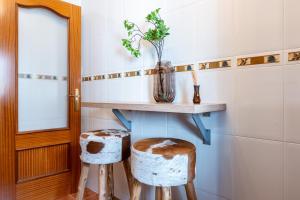 a bathroom with a table and two stools at Mirage Mijas centro in Mijas +14 photos