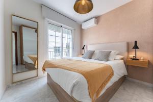 a bedroom with a large bed and a large window at Mirage Mijas centro in Mijas