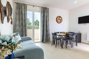 a living room with a blue couch and a table at Helianthus in Cisternino