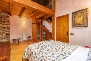 a bedroom with a bed in a room with wooden ceilings at Cobert de Felip in Gavas