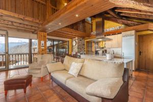 a living room with a couch and a kitchen at Cobert de Felip in Gavas
