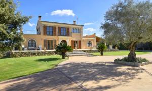 a large house with trees in front of it at Llum in Manacor