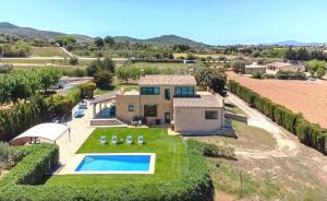 an aerial view of a house with a swimming pool at Llum in Manacor