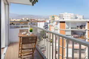 a balcony with a table and a view of a city at Marineros Sureste A111 in Torre del Mar