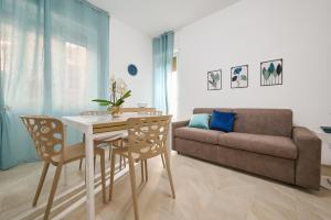 a living room with a table and a couch at Casa La Viola - Follonica in Follonica