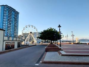 an empty street with a ferris wheel in a city at Casa La Viola - Follonica in Follonica
