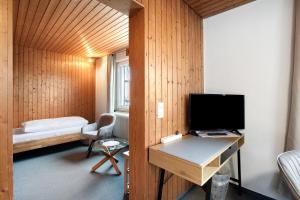 a room with a desk with a computer and a bed at Hotel Garni Siedlerstube in Nürtingen