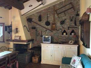 a kitchen with a stone wall with a fireplace at Il Forcone in Panicale