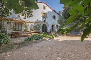 a building with a bench in front of it at Mas Juli in Pineda de Mar