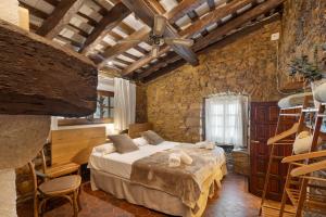 a bedroom with a large bed in a brick wall at Mas Juli in Pineda de Mar +37 photos