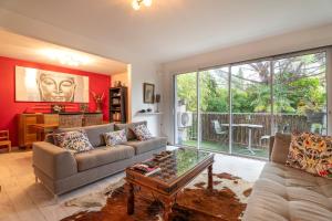 a living room with a couch and a table at Appartement Atypique avec terrasse in Hyères