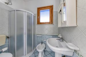 a bathroom with a shower and a sink and a toilet at Rocco 1 in Torre San Giovanni Ugento