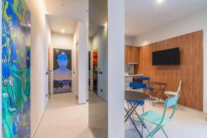 two views of a living room and a dining room with blue chairs at Bellini House in Viagrande
