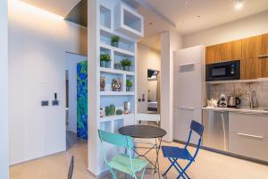 a kitchen and dining room with a table and chairs at Bellini House in Viagrande