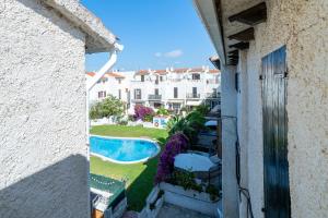 a view from a balcony of a house with a swimming pool at Casa Manolo in Torredembarra