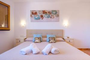 a bedroom with a large bed with two pillows at Casa Cristina Ibiza in Sant Carles de Peralta