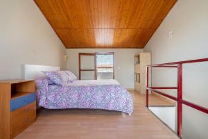 a bedroom with a bed and a wooden ceiling at Casa Manolo in Torredembarra +21 photos